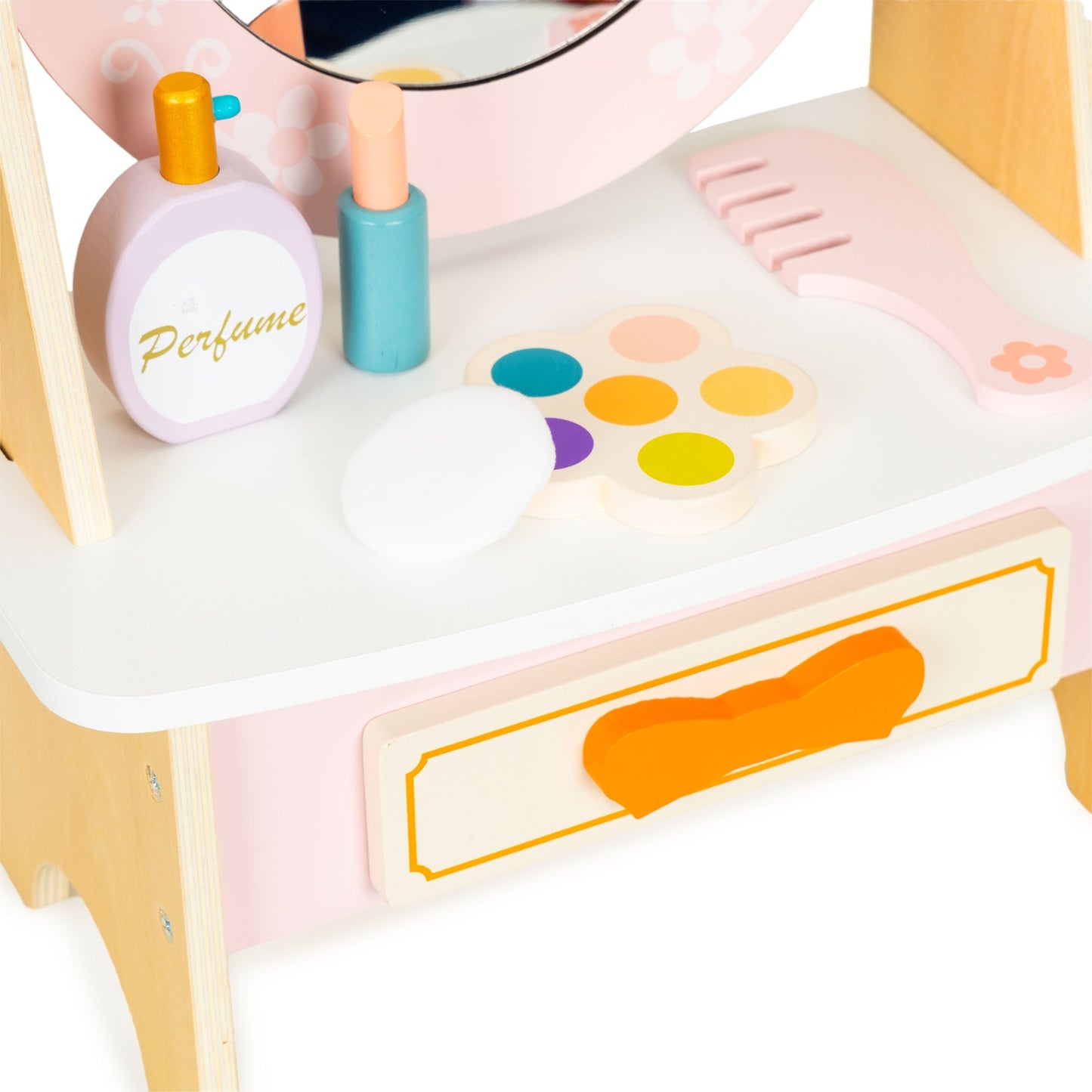 Wooden dressing table with pink children's accessories
