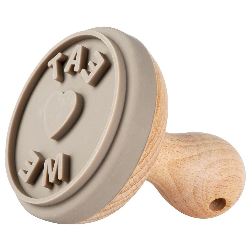Wooden stamp for cake decoration with the text Eat Me