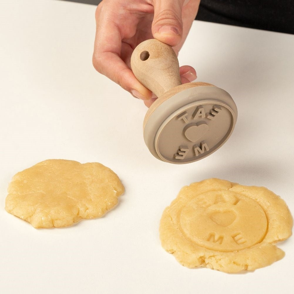 Wooden stamp for cake decoration with the text Eat Me