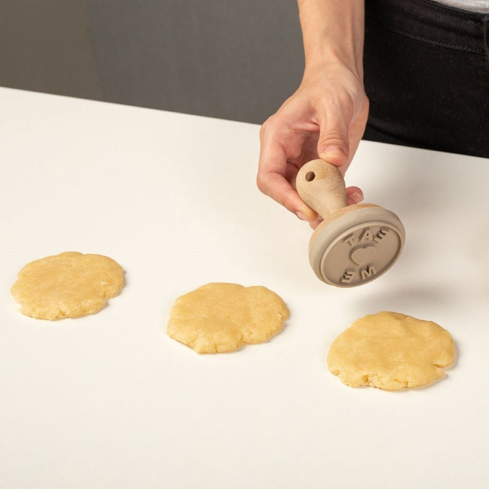 Wooden stamp for cake decoration with the text Eat Me