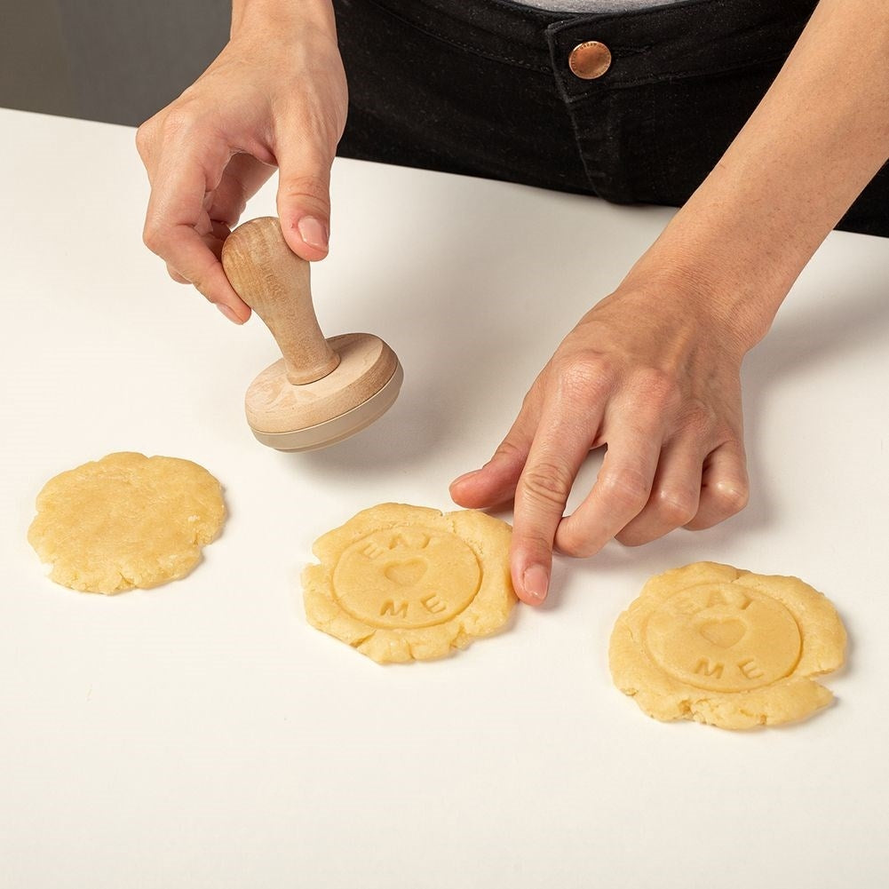 Wooden stamp for cake decoration with the text Eat Me
